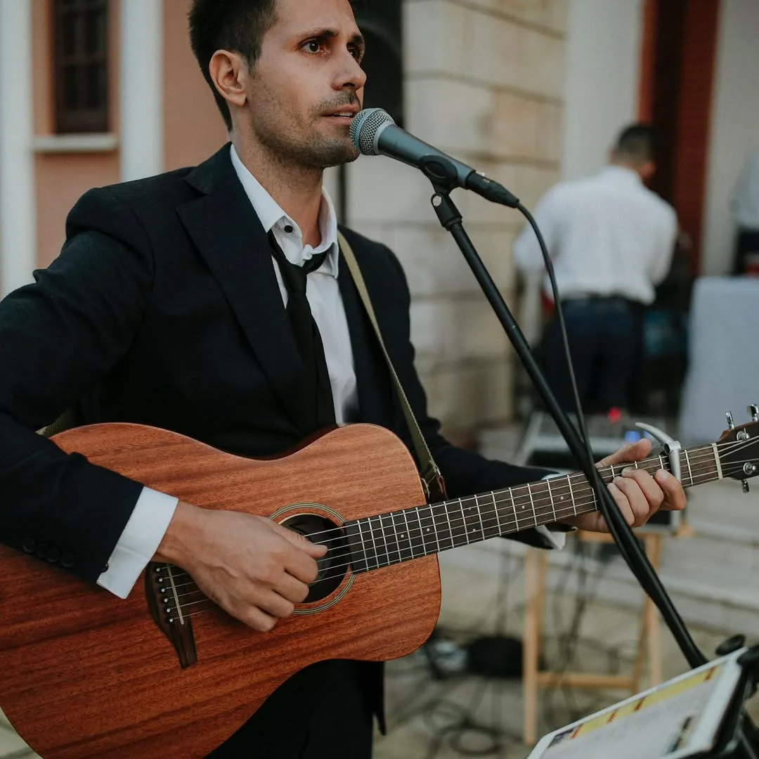 Stelios Antoniou performing at a wedding in suit